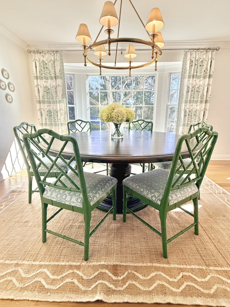 Dining room with green upholstered chairs and elegant table setting